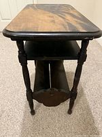 front view showing top surface, middle shelf, magazine rack