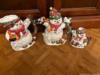 All three ceramic snowman figurines displayed together