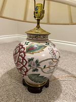 Full view of porcelain floral table lamp with shade
