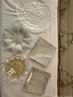 Group shot of five glass plates displaying shapes and designs