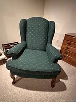 front view of green wingback chair