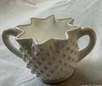 Milk glass hobnail sugar bowl showing hobnail texture, star rim and twin handles
