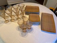 Amber stemware, tumblers and bamboo pattern plates and platter displayed on table
