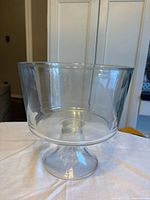 Clear glass pedestal bowl on table