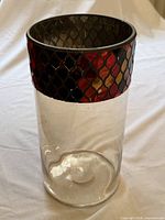 Full view of vase showing clear body and mosaic tile band