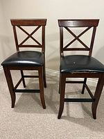 Front view of both wood X-back counter stools