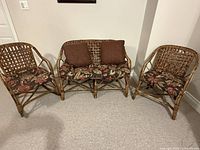 Front view of all three rattan seating pieces with cushions