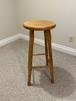 Full view of solid wood bar stool showing height and design