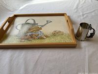 Tray and pewter tankard side by side on white surface