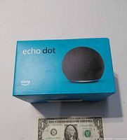 Front/top view of Echo Dot boxed with scale reference