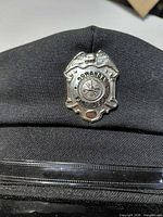 Front view showing silver Gowanda Fire Dept badge on hat