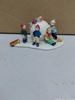 Front view showing children, sled, dog and snowball