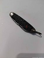 Knife closed showing handle texture, bail, bolsters