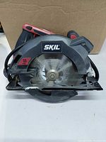 Front view of SKIL circular saw showing blade, shoe and specifications