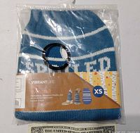 Front of packaged blue XS sweater showing brand, size, design