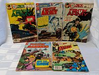 Five Charlton war comics laid out front covers visible