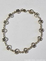 Full view of bracelet showing repeating Claddagh links and clasp