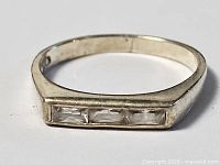 Top view of sterling silver ring showing three channel-set clear crystals