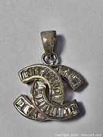 Front view showing silver pendant with clear baguette stones