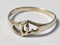 Sterling silver ring showing open entwined hearts design
