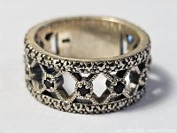 Front perspective of sterling silver lattice ring with garnets