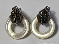 Full view of both earrings showing overall design and material