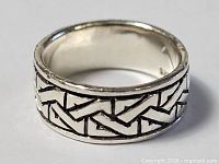 Front perspective of sterling silver band ring showing geometric design
