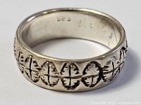 Full view of sterling silver ring showing carved pattern and 925 stamp