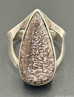 Front view of teardrop gembone cabochon set in sterling silver split-shoulder ring