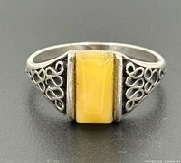 Front view of sterling silver ring with rectangular butterscotch amber stone