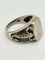 Side view of sterling silver signet ring showing scorpion detail