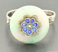 Front view of ring showing jadeite disc and blue enamel flower