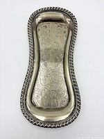 Top view of engraved Sheffield plate snuffer tray