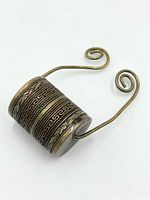 Side view showing etched brass and copper cylinder and wire handle