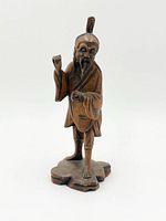 Front view of carved wooden Chinese figure on base