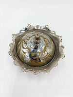 Top view of lidded dish showing floral design and scalloped rim