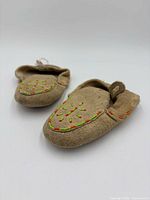 Pair of moccasins angled view showing beadwork