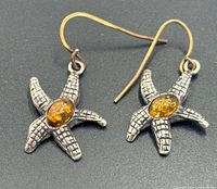 Front view of earrings showing starfish shape and amber stones