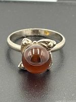 Front view of sterling silver ring with amber sphere