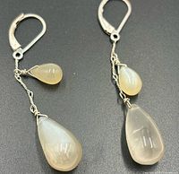 Front view of both earrings showing moonstone drops, sterling wirework, leverbacks