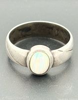 Front view of sterling silver ring with oval opal