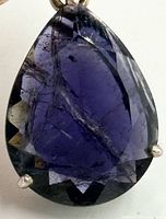 Front view of pear-cut iolite showing color and inclusions