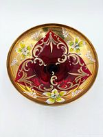 Top view showing ruby red glass, gold overlay and enamel floral decoration