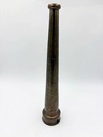 Full view of brass fire hose nozzle standing upright