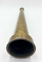 Full length view of brass fire hose nozzle from threaded base to tip