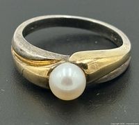 Ring top view showing pearl and two-tone bypass design