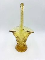 Full frontal view showing floral etching, handle and base