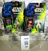 Front view of both sealed action figures in original packaging