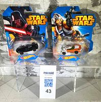 Front view of two sealed Star Wars Hot Wheels cars