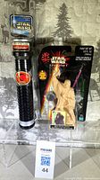Front view of sealed lightsaber and figure painter packaging